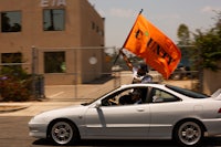 a white car with an orange flag